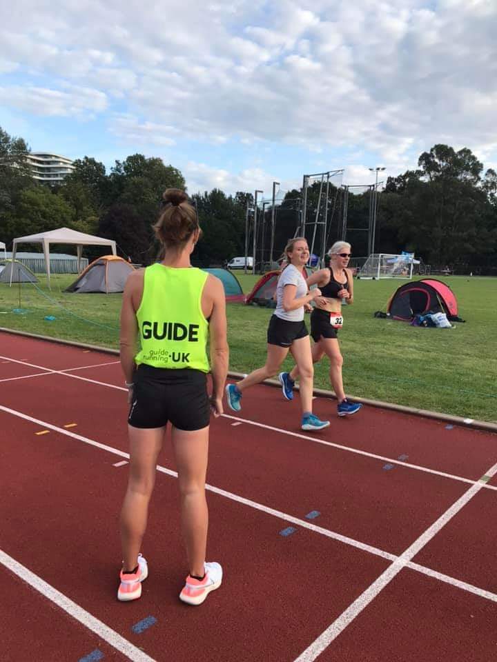 Two women, including Ultra Runner Sinead Kane, running a race track